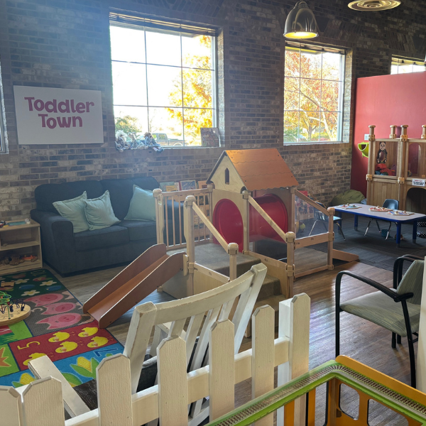 Exhibit with little playgrounds, books, and toys for tots