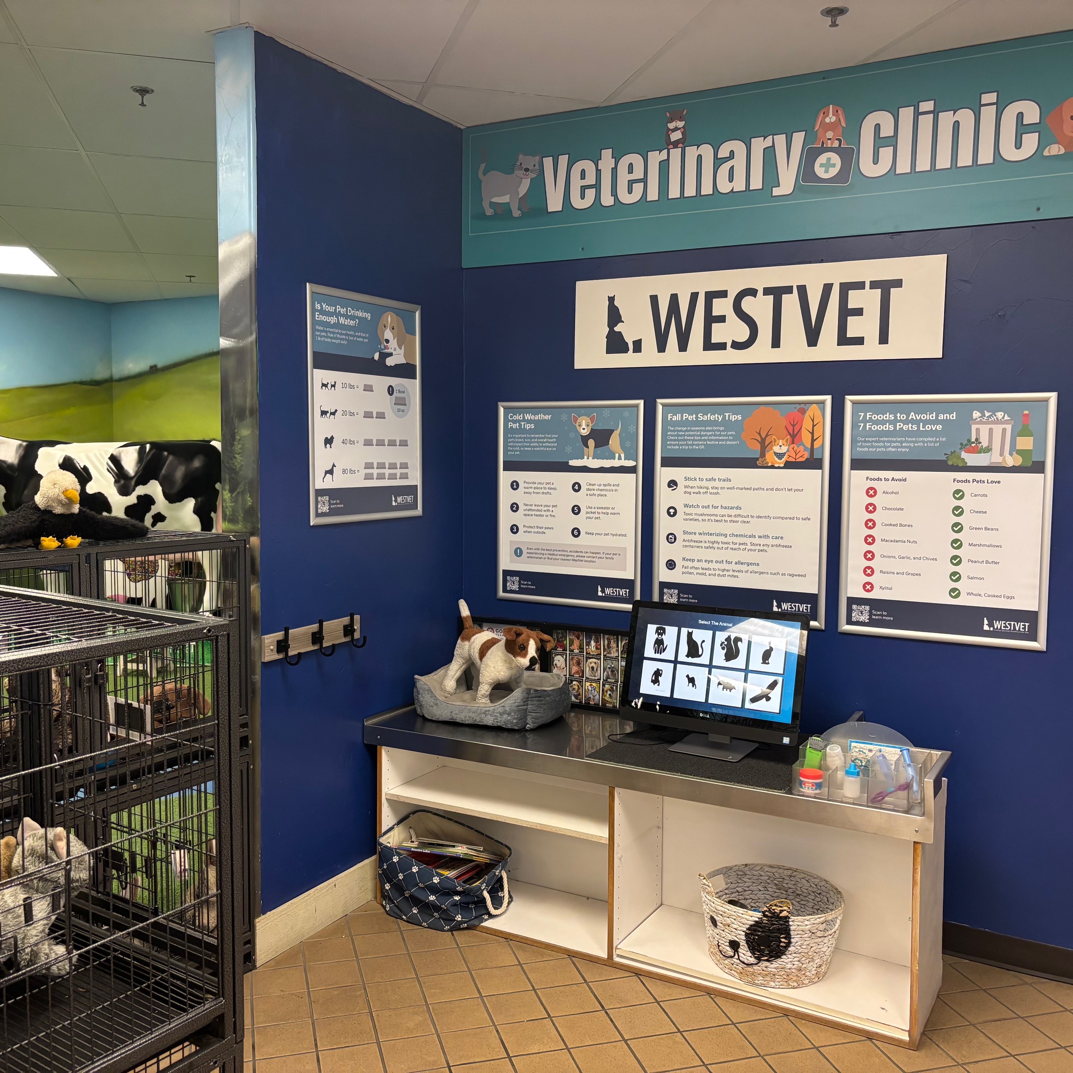 Exhibit with cages of stuffed animals, x-ray monitor, and various vet accessories