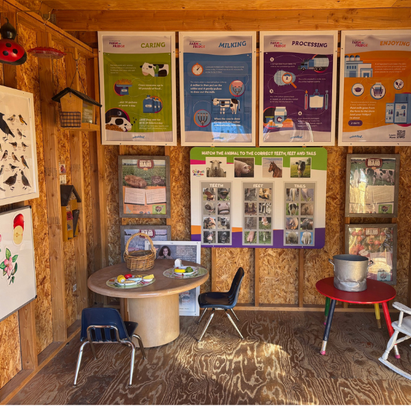 Inside barn with informational posters about farming and pretend play food