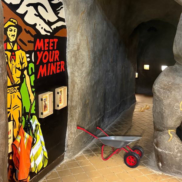 Entrance to mine with mining information graphic on the wall