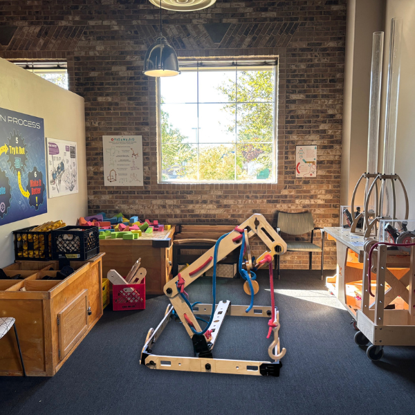 Room with rig-a-ma-jig building supplies, foam blocks, and bottle launchers.